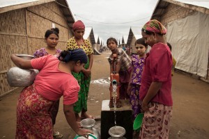 A group of young Rohingya girls fill their jars with water from one of the few water pumps available to the IDPs living in Rabba Garden IDP camp. (PHOTO: Marta Tucci)