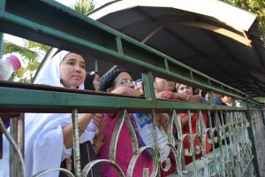 Women watch on as Ko Ni was laid to rest on 30 January, 2016. (PHOTO: KIMBERLEY PHILLIPS / DVB)
